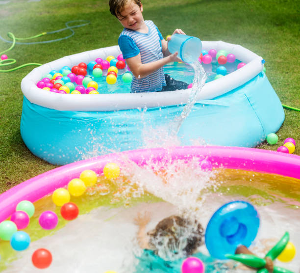 istock Young caucasian boy in inflatable pool enjoying water 861176334