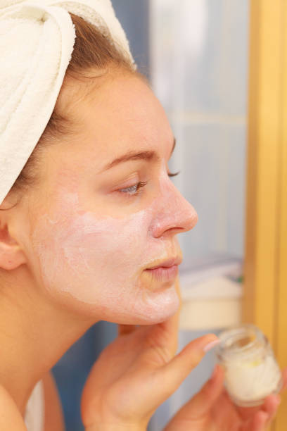 istock Woman applying mask cream on face in bathroom 861177684