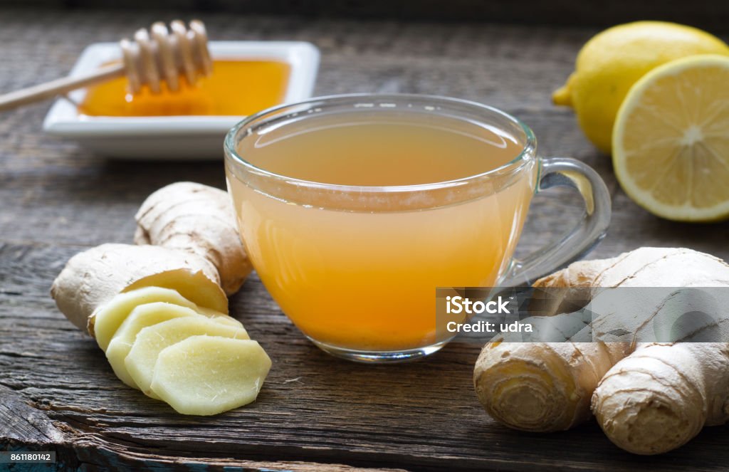 Ginger homemade tea infusion on wooden board with lemon Ginger homemade tea infusion on wooden board with lemon still life Ginger - Spice Stock Photo