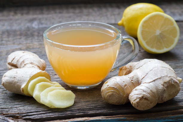 istock Ginger homemade tea infusion on wooden board with lemon 861180242