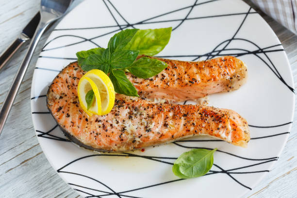istock Grilled Salmon steak with lemon and herbs. 861189280