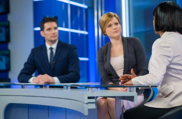 Journalists Sitting With Businesswoman