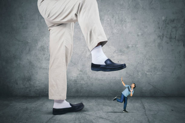 istock African man running from his boss foot 861190184