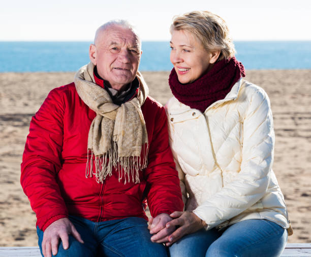 istock Mature couple sitting by sea 861190630
