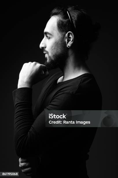 Studio Shot Of Young Bearded Indian Man With Hair Tied Back In Black And White Stock Photo - Download Image Now - iStock Studio Shot Of Young Bearded Indian Man With Hair Tied Back In Black And White Stock Photo - Download Image Now - iStock