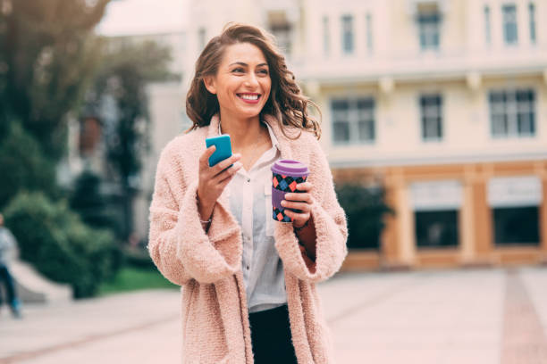 istock Woman texting and drinking coffee in the city 861195144