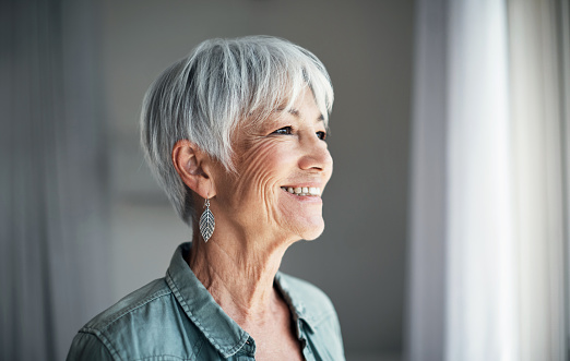 An attractive lady with gray hair and a wrinkled face.