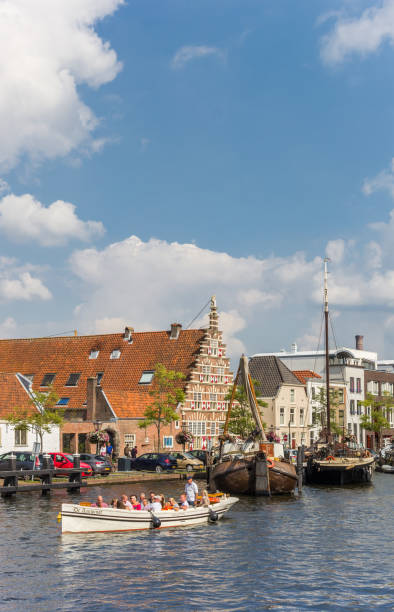Tourists at a boat tour in the canals of Leiden, Holland Leiden, Netherlands - September 03, 2017: Tourists at a boat tour in the canals of Leiden, Holland upper mast house stock pictures, royalty-free photos & images
