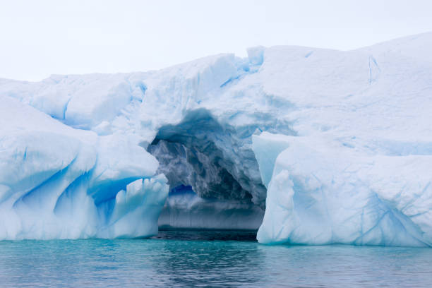 istock A huge cave has been carved in tho this iceberg. 861206126