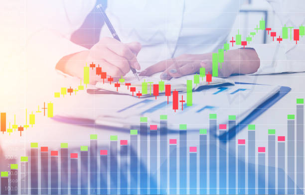 istock Businesswoman writing in office, graphs 861206300