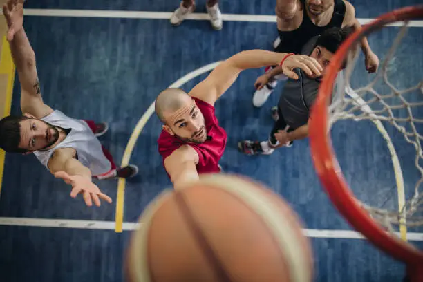 Photo of Above view of determined basketball players in action.