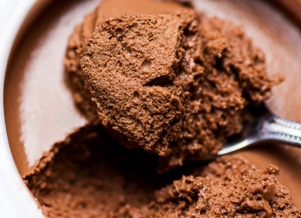 istock Chocolate Mousse in White Cup Bowl. Spoonful Visible  Spongy Texture with Pores. Vibrant Rich Brown Color. Macro Close up 861218520