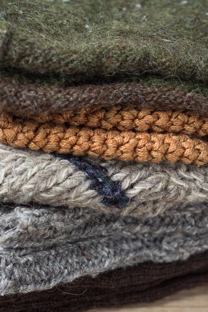 istock Stack of Handmade Warm Knitted Socks Scarfs Mittens From Rough Wool Yarn Brown Beige Grey. Close up. Winter Autumn Eco Fashion Kinfolk Style. Natural Materials 861219900