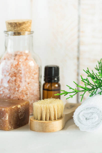 istock Handmade Coal Tar Soap Pink Himalayan Salt Essential Oil Towel Brush Juniper Twig on White Marble Background. Spa Wellness Relaxation Body Care Skincare Concept. Natural Products 861220598