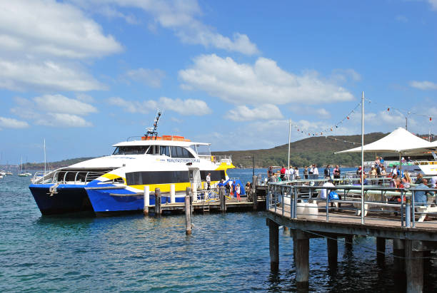 hombres fast ferry barco listo para recoger pasajeros y parten al muelle de cirqular sydney manly wharf - depart fotografías e imágenes de stock