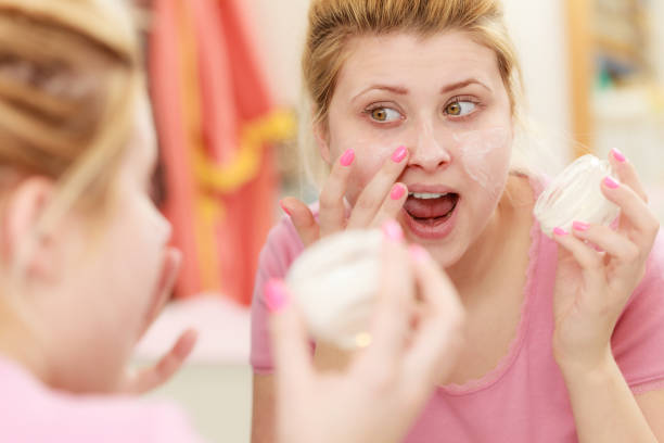 istock Woman applying face cream with her finger 861223168