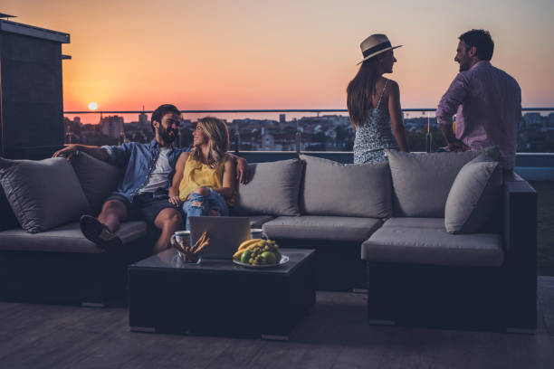 istock Young happy couples talking among themselves on a penthouse patio. 861223872