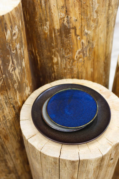 istock Vintage blue and black plates on a wooden stump 861226524