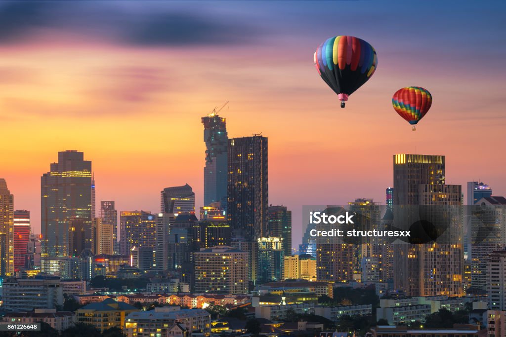 Hot air balloon over Bangkok business district at dusk, Thailand Above Stock Photo