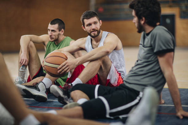 istock Young basketball players communicating while relaxing on the court. 861227266