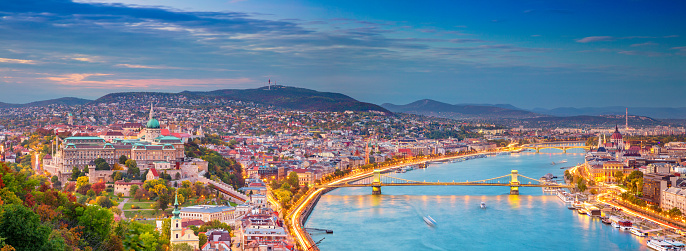 Panoramic cityscape image of Budapest, capital city of Hungary, during sunset.