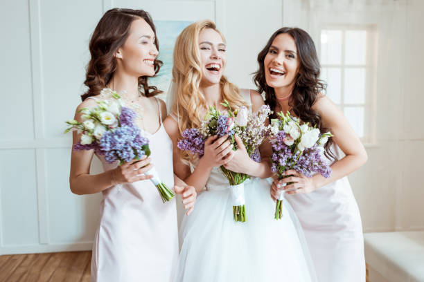 laughing bride with bridesmaids beautiful laughing bride with bridesmaids holding bouquets beautiful bride stock pictures, royalty-free photos & images