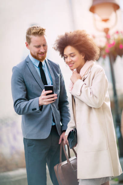 istock Happy business couple using smart phone outdoors 861247346