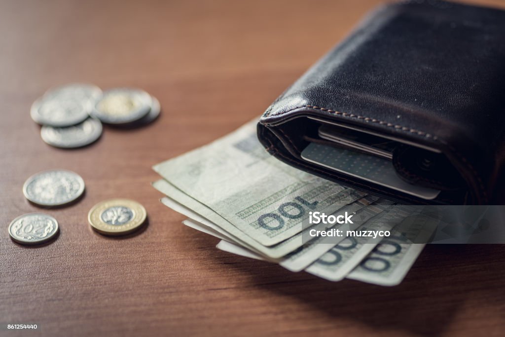 Walet with polich money Polsih PLN money, coins and notes, on the table near the lether walet. Currency Stock Photo