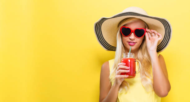 istock Happy young woman drinking smoothie 861259918