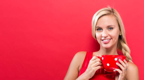istock Happy young woman drinking coffee 861260268
