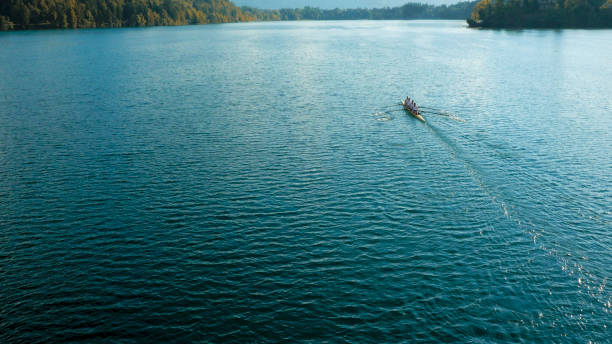 istock Four male athletes sculling on lake in sunshine 861260734