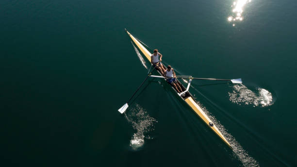 istock Two male athletes sculling on lake in sunshine 861260754