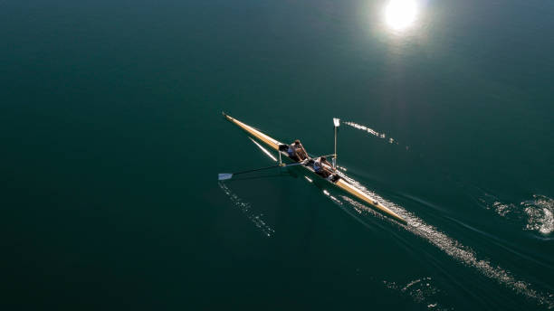 istock Two male athletes sculling on lake in sunshine 861260766
