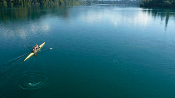 istock Two male athletes sculling on lake in sunshine 861260798