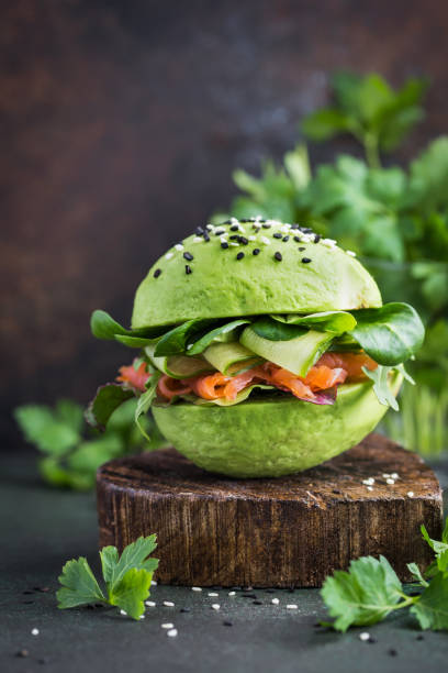 istock healthy raw avocado burger with salted salmon and fresh vegetables.  selective focus 861268202