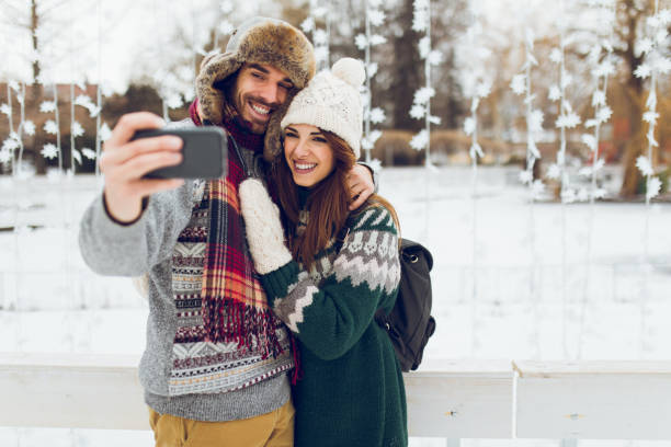 istock Young romantic couple taking Selfie while ice-skating 861268354