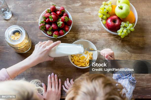 Mother With Child Having Breakfast Stock Photo - Download Image Now - Breakfast, Family, Child