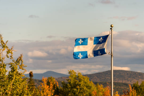 Quebec flag and fall colours in Autumn Quebec flag and fall colours quebec stock pictures, royalty-free photos & images