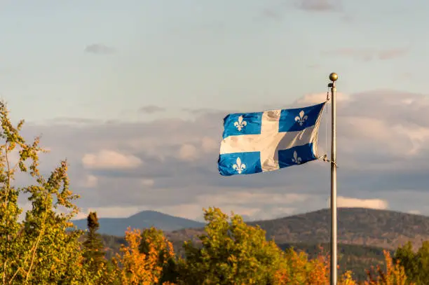 Photo of Quebec flag and fall colours in Autumn