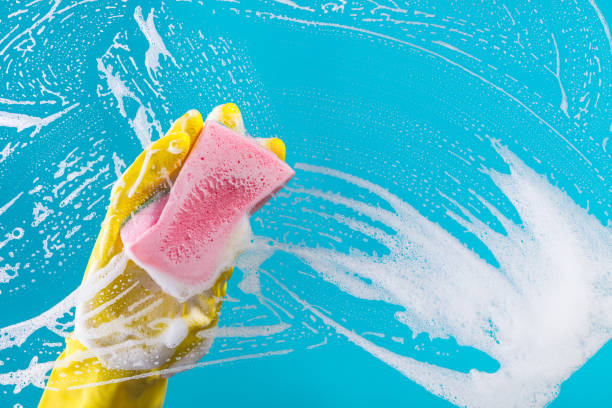 istock hand cleaning glass window pane with detergent 861275948