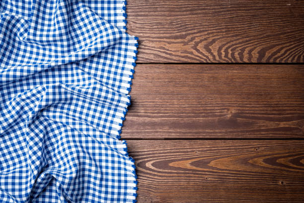 istock Blue checkered tablecloth on an old wooden table 861276016