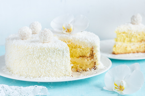 festive lemon and coconut sponge cake, selective focus