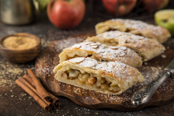 istock homamade apple strudel, decorated with almond and powdered sugar on rustic background 861277088