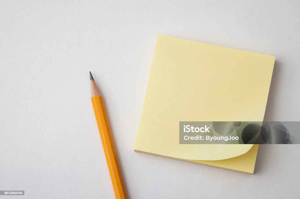 Yellow Sticky Paper And Pencil On White Backgrounds Business