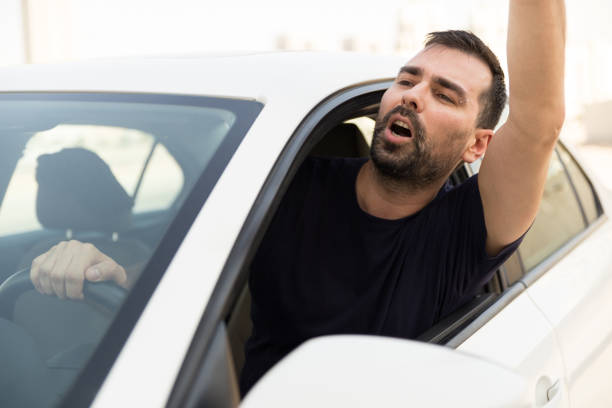 istock Angry man driving a vehicle is expressing his road rage. 861287456