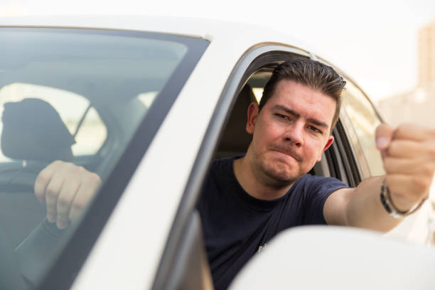 istock Angry man driving a vehicle is expressing his road rage. 861287486