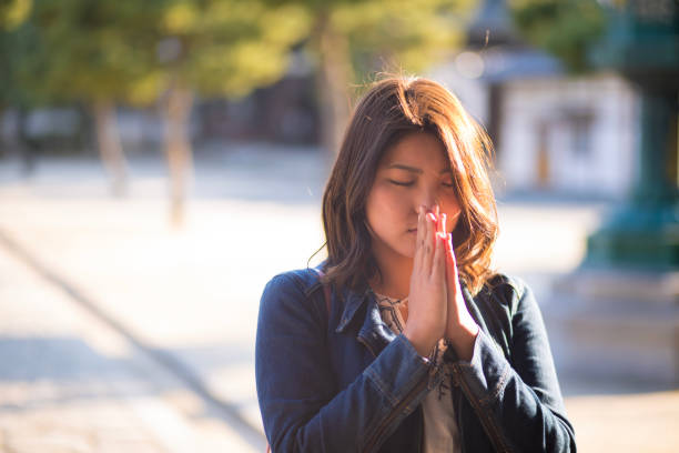 istock Young woman praying for peace in temple 861287606