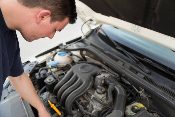 istock Man examining under hood of car 861290878