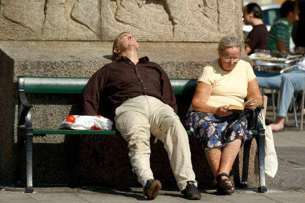 stockholm sweden  august 24 - 2005  - two unidentified person rests on a bench in Stockholm city and at the old town in the middle of Stockholm and from Sweden