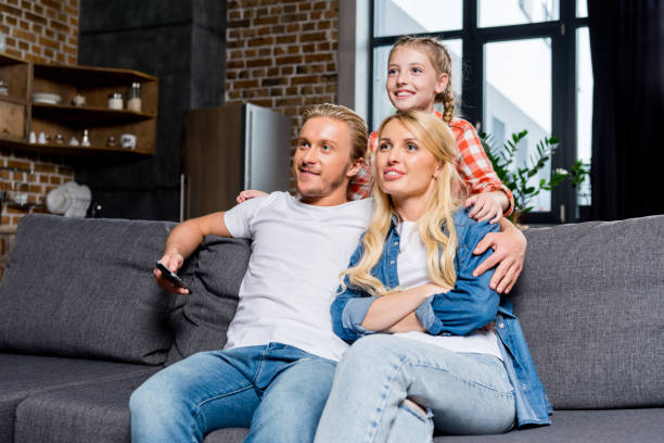 istock parents with child watching tv 861292678